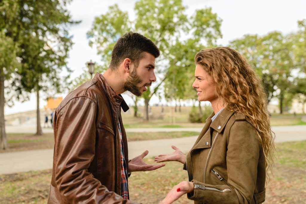 Guy showing aggression to girlfriend in a relationship conflict